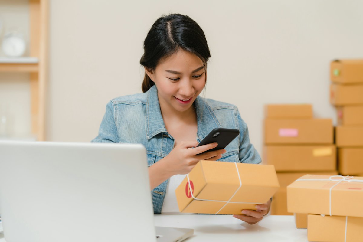 A seller checking a packed order against their phone.